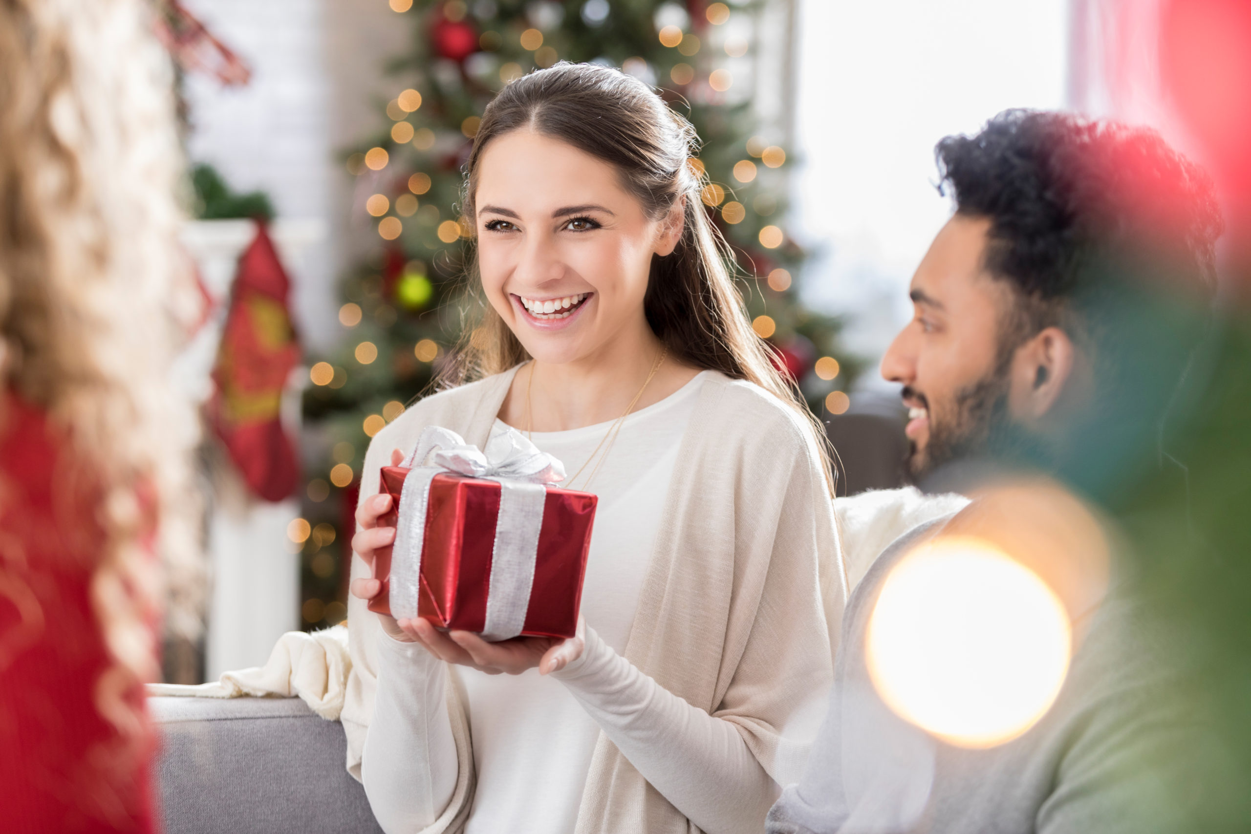 Millennial friends exchange gifts at Christmas