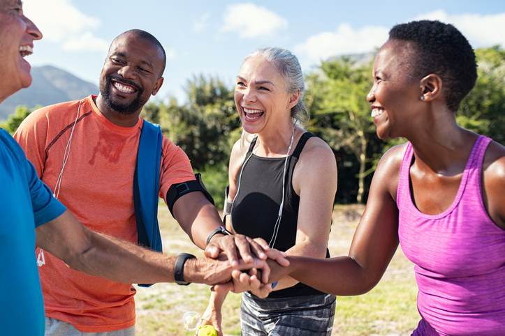 Mature people stacking hands after workout Mature people stacking hands after workout