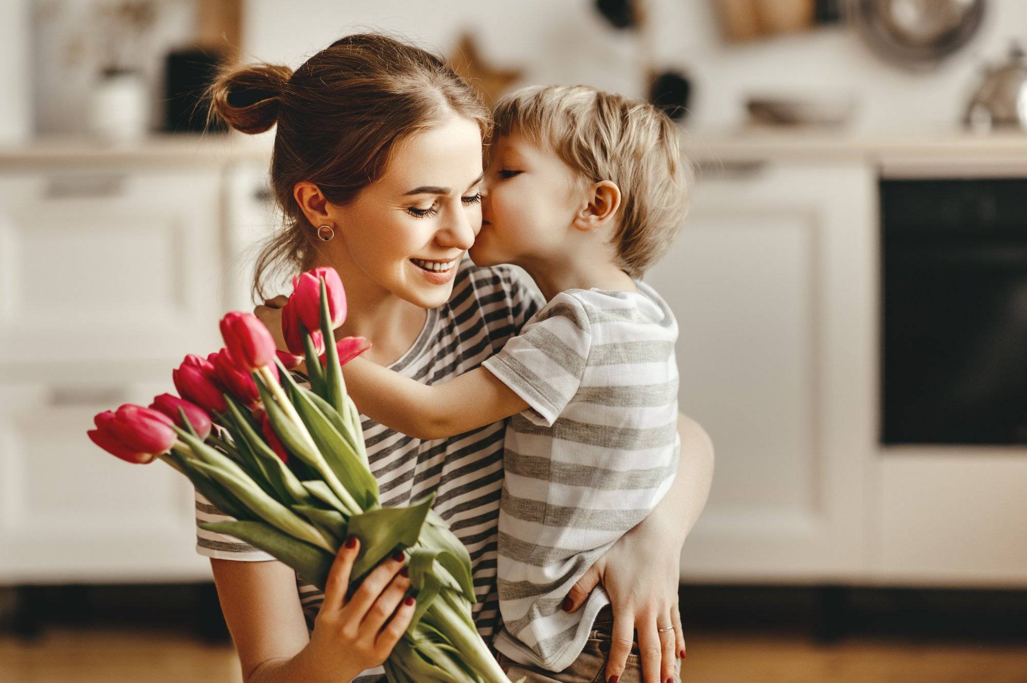 happy mother’s day! child son gives flowers for mother on holiday happy mother's day! child son gives flowers for mother on holiday