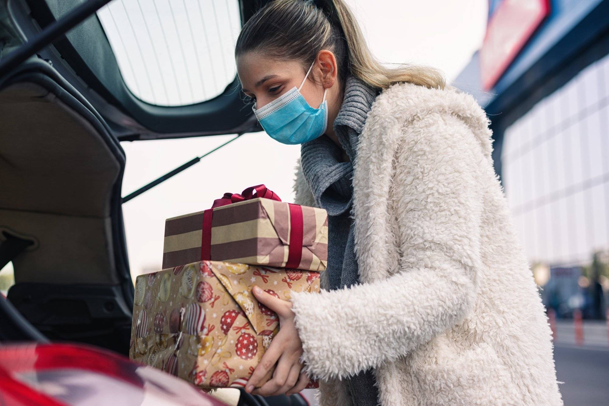 Teenage girl wears a protective mask while shopping for Christmas during COVID-19 pandemic Teenage girl wears a protective mask while shopping for Christmas during COVID-19 pandemic