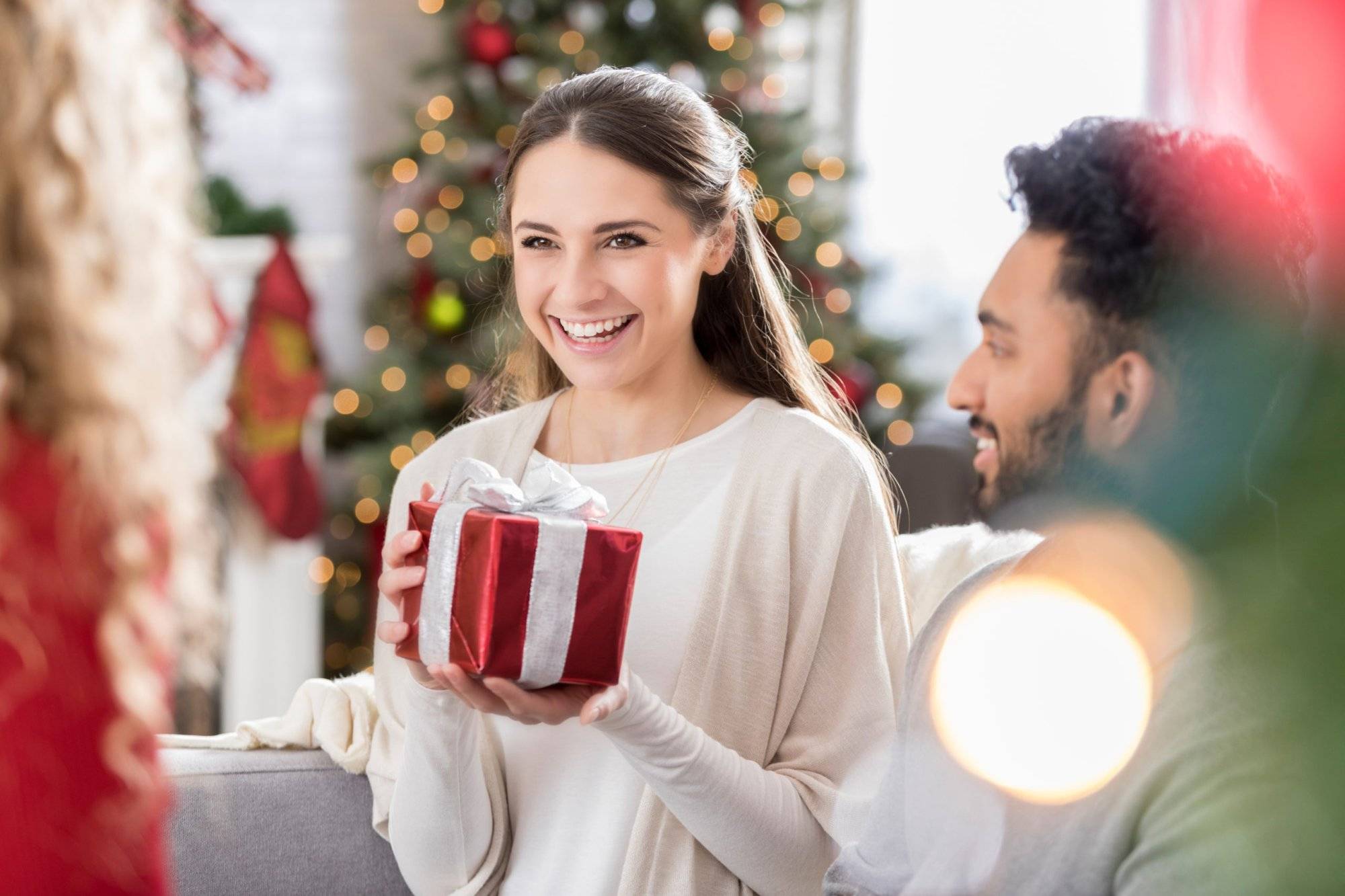 Millennial friends exchange gifts at Christmas Millennial friends exchange gifts at Christmas