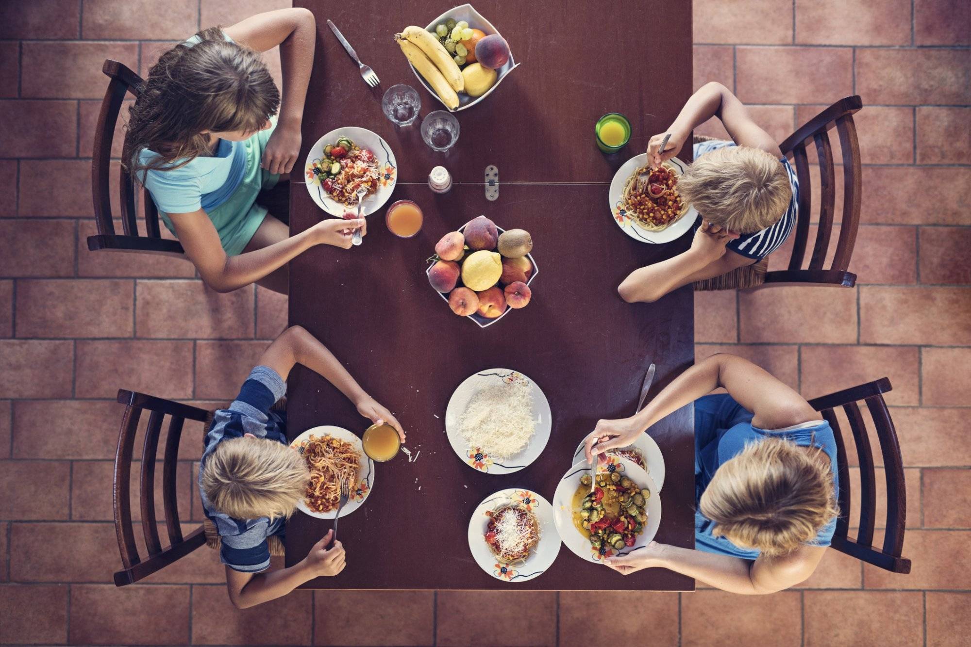 Family enjoying spaghetti lunch Family enjoying spaghetti lunch