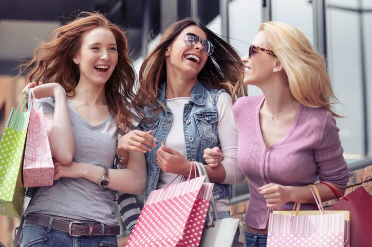 Young attractive girls with shopping bags in the city