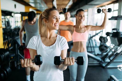 Picture of two beautiful fitness women in gym